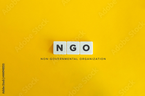 NGO (Non Governmental Organisation) banner and concept. Block letters on bright orange background. Minimal aesthetics. photo
