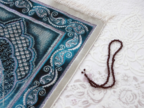 prayer mat and rosary laid on the ground for worship, prayer rug in islam,