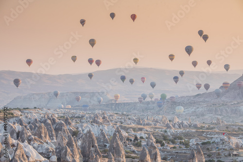 Hot air balloon flying over rock landscape at Cappadocia Turkey