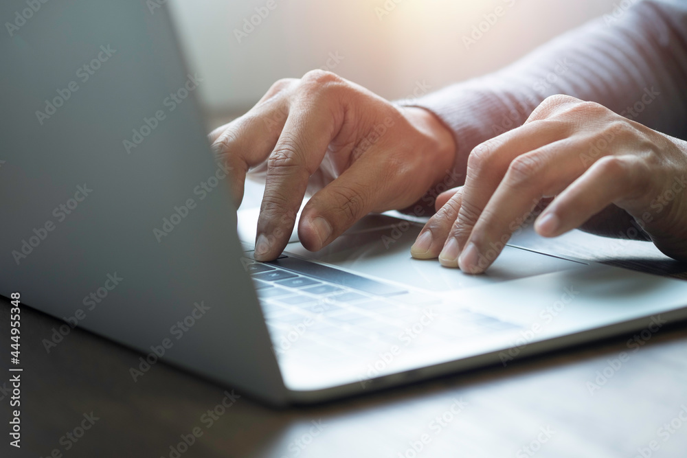 Close-up of man hands using and typing keyboard of laptop computer on office desk. Workspace, businessman working project creative idea for job online network. Business finance and technology concept. Close-up of man hands using and typing keyboard of laptop computer on office desk. Workspace, businessman working project creative idea for job online network. Business finance and technology concept.