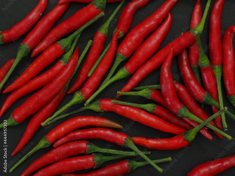 chili peppers on a black background
