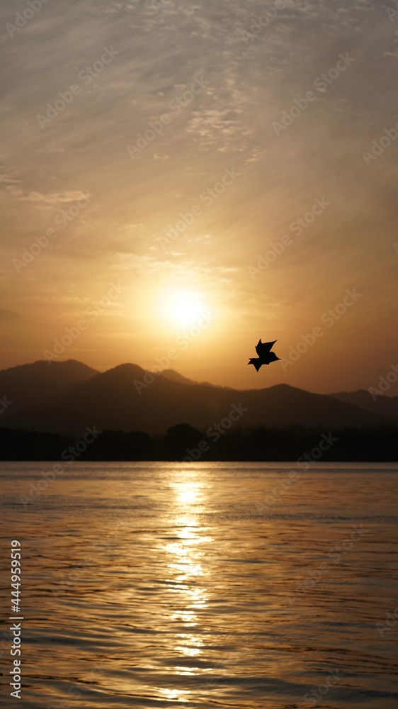 The beautiful sunset view with the lake and mountains as background in winter