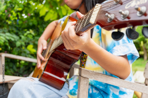 girl playing classical guitar