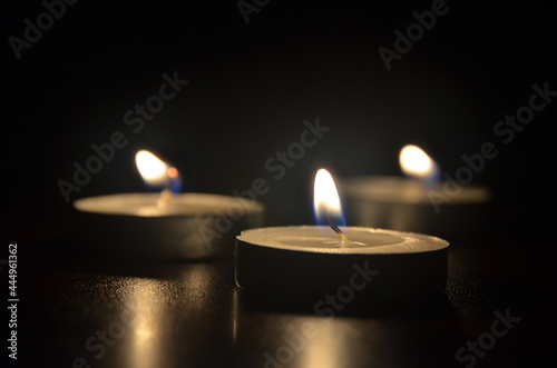 Candles trying to illuminate the darkness