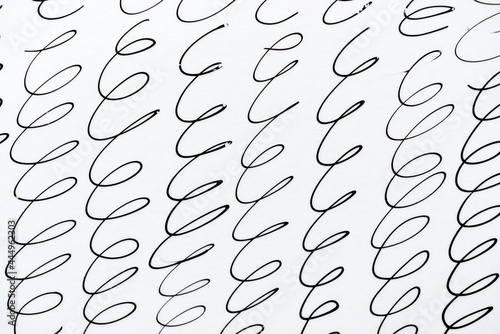 abstract curly or cursive background in black ink on white - vertical photo