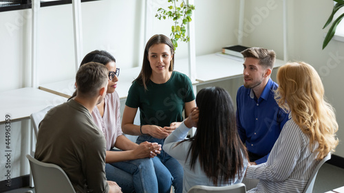 Diverse millennial team discussing mental health problems on group therapy meeting. Recovering addicts getting psychologist and community support, telling own addiction story on rehab session photo