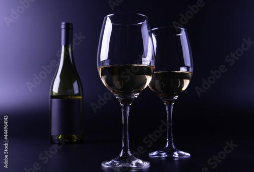 wine glass with bottle and black background
