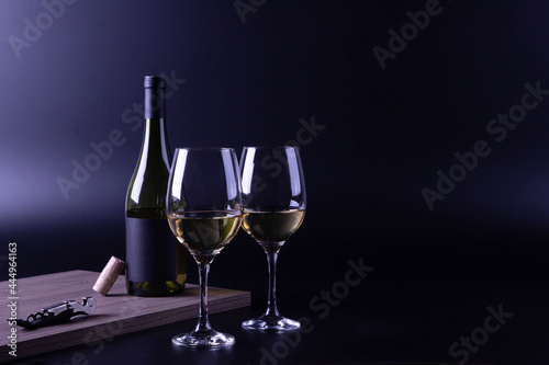 wine glass with bottle and black background