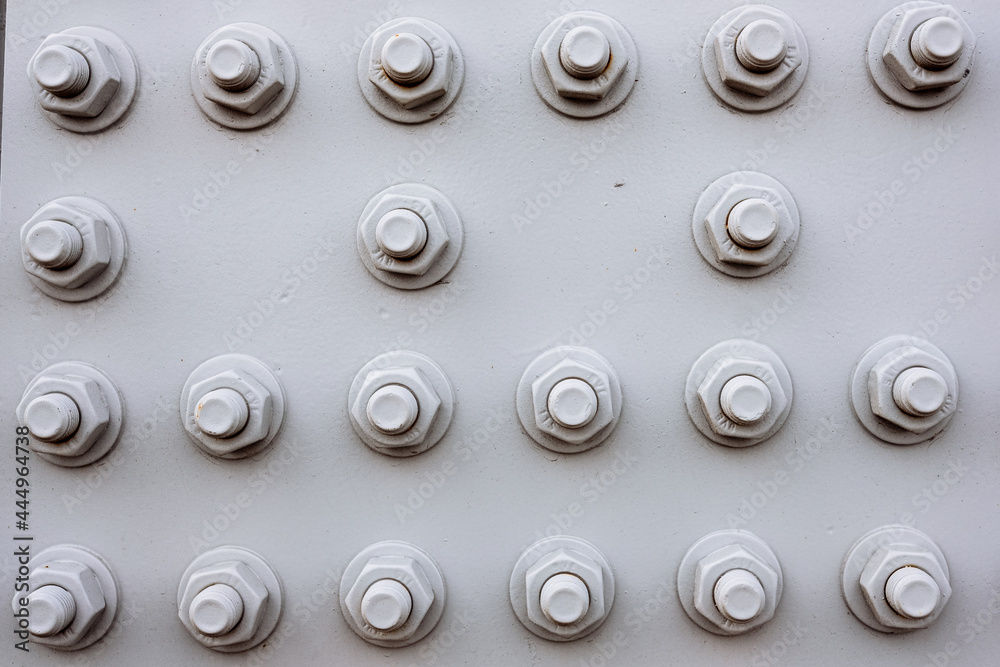 The texture: abstract background of bolts and nuts painted gray on The texture: abstract background of bolts and nuts painted gray on