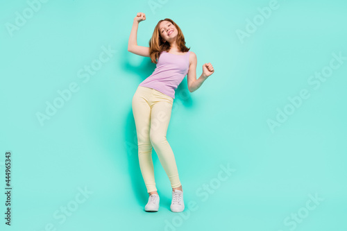 Full body photo of funky blond hairdo little girl dance wear violet top trousers isolated on teal color background