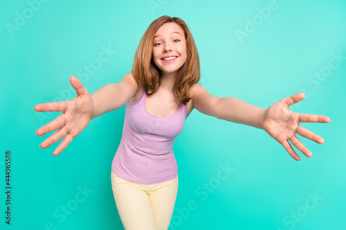 Photo portrait schoolgirl in singlet happy smiling hugging embracing isolated bright teal color background
