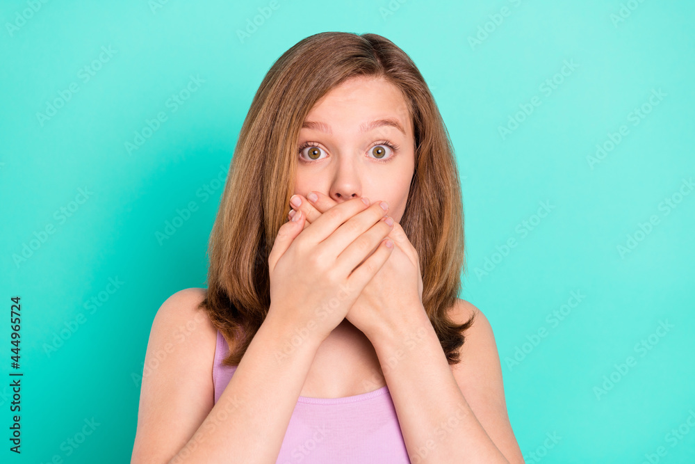 Photo of sad blond hairdo teen girl close mouth wear violet top isolated on teal color background Photo of sad blond hairdo teen girl close mouth wear violet top isolated on teal color background