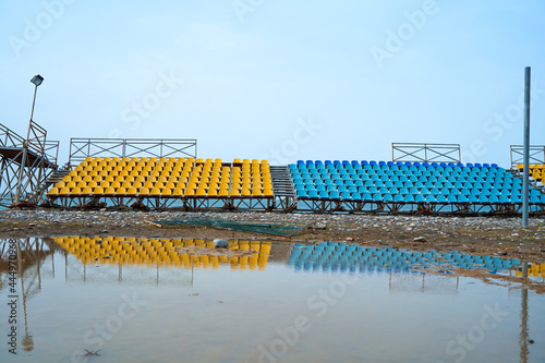 Deserted stands of a small sports field on the beach on a rainy day