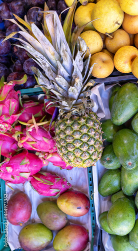 Fototapeta Naklejka Na Ścianę i Meble -  Fresh tropical fruits, vegetable supermarket counter. Selling crops on the market. Vertical image.