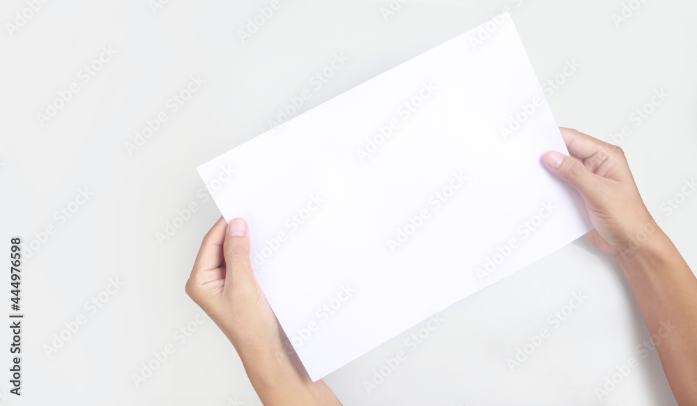 Hands holding paper blank for letter paper Hands holding paper blank for letter paper