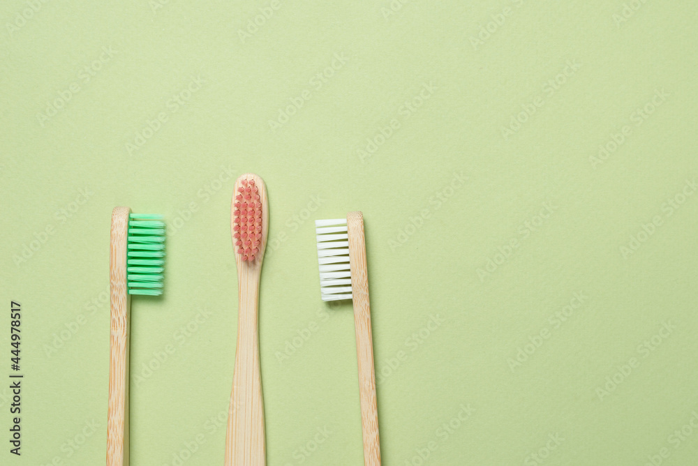 Bamboo toothbrush on a green background. Bamboo toothbrush on a green background.