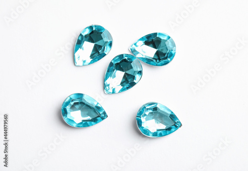 Beautiful gemstones on white background  top view