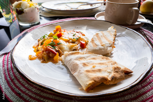 Scrambled eggs with lavash roll  coffee in a cup.