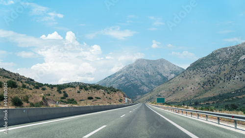 Driving car on a highway with view on scenic hills and mountains  European road.