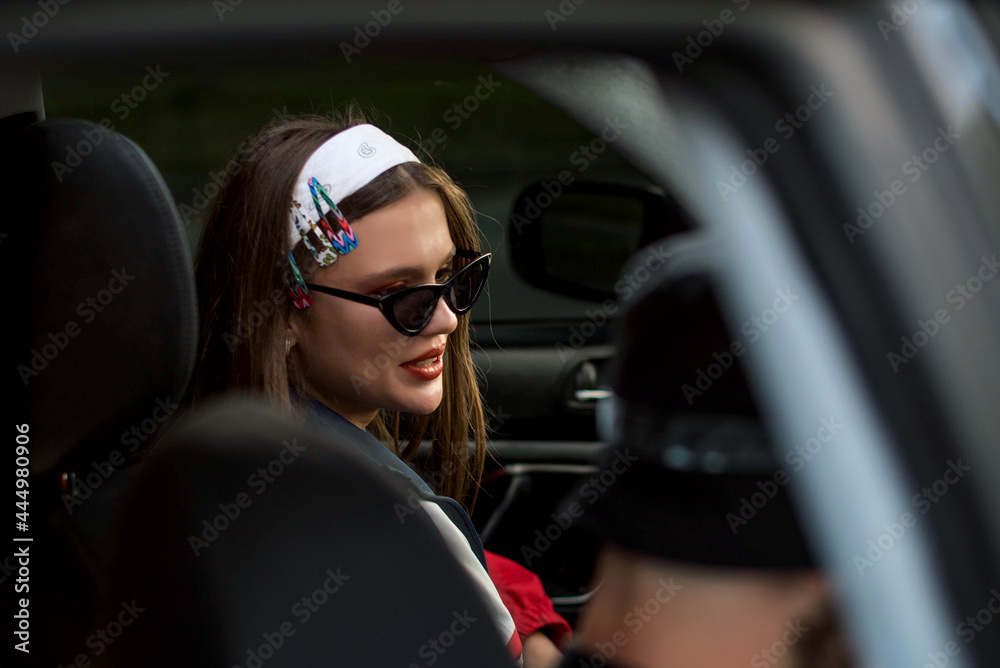 Beautiful cute teenage country girl in 90s style in car Back in time 80s. Stylish retro dressed in street style clothes with chains around. Youth and lifestyle concept Beautiful cute teenage country girl in 90s style in car Back in time 80s. Stylish retro dressed in street style clothes with chains around. Youth and lifestyle concept