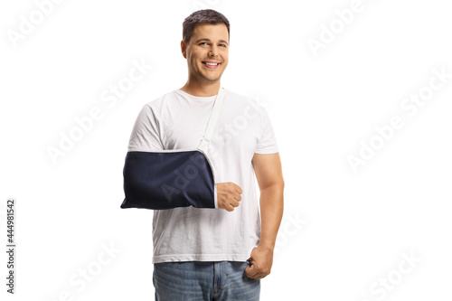 Young man with a broken arm wearing an arm splint and smiling photo