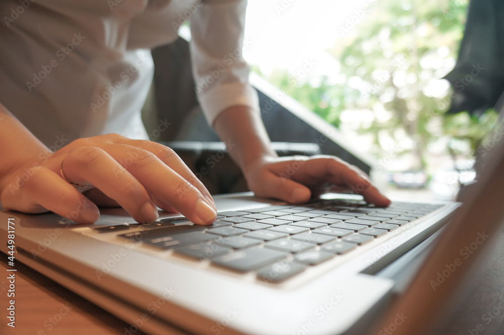 Woman working by using a laptop computer Hands typing on keyboard. writing a blog. Working at home are in finger typewriter