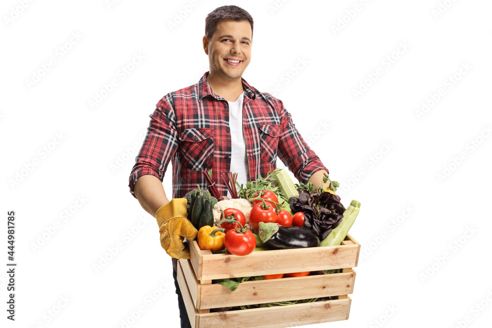 Farmer holding a crate with vegetables and looking at camera Farmer holding a crate with vegetables and looking at camera