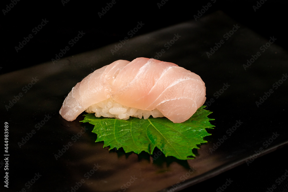 Suzuki sushi on oba leaves, Eating sushi at restaurant, japanese cuisine - obrazy, fototapety, plakaty 