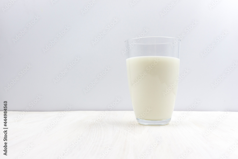 Glass of milk on a white wooden table Glass of milk on a white wooden table