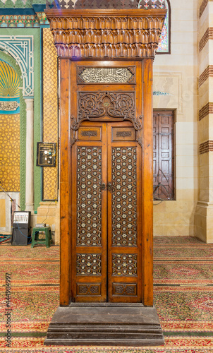 Old aged wooden door of Minbar of Imam Al Shafii Mosque with arabesque decorations tongue and groove assembled, inlaid with ivory and ebony, Old Cairo, Egypt photo