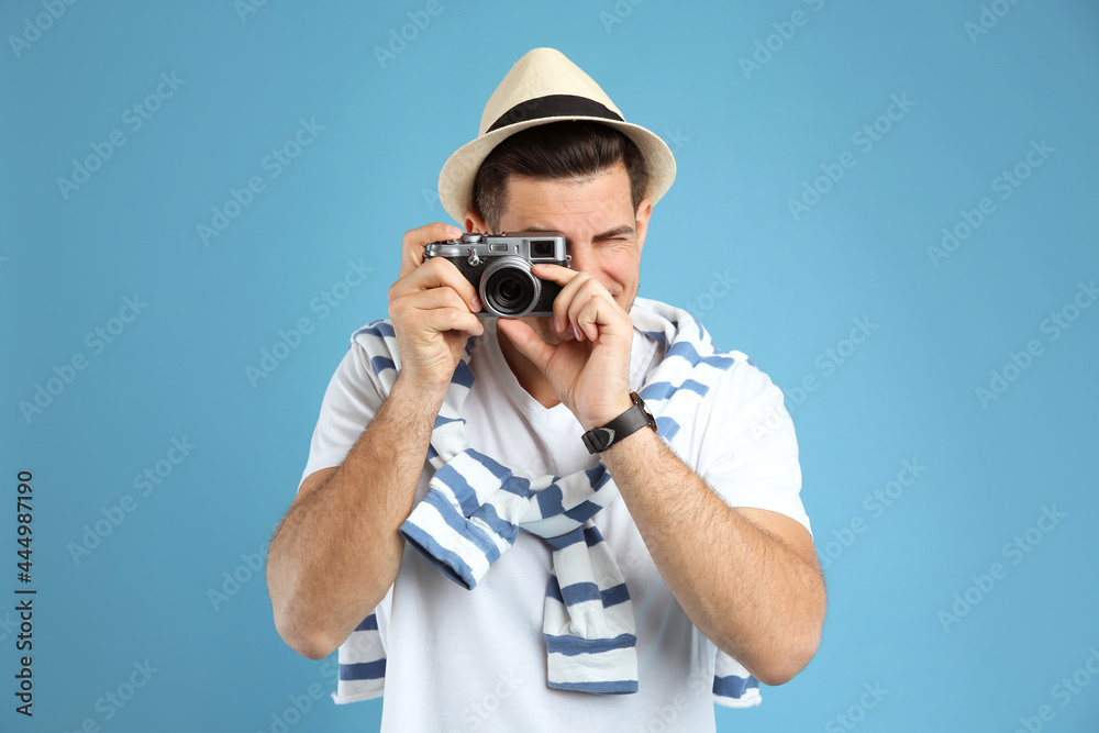 Male tourist taking picture on turquoise background Male tourist taking picture on turquoise background