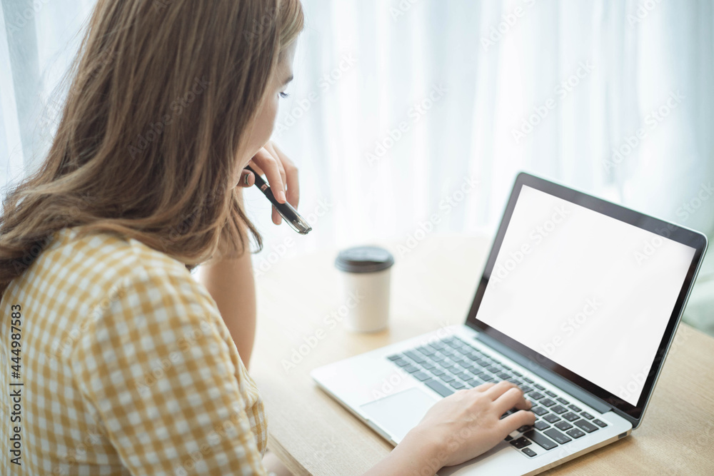 Entrepreneur concept a young businesswoman typing on a laptop to reply emails to her customers Entrepreneur concept a young businesswoman typing on a laptop to reply emails to her customers