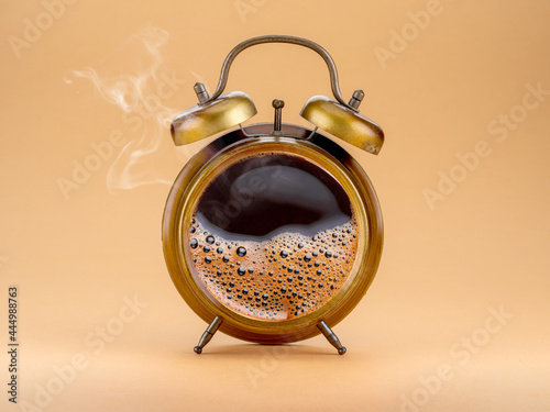 Steamy coffee drink collage. Hot coffee inside of a'larm clock as a symbol coffee time.Steamy coffee drink collage. Hot coffee inside of a'larm clock as a symbol of coffee time.