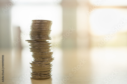 Money and Financial Concept. Closeup of stack of silver coins on wooden table with copy space.