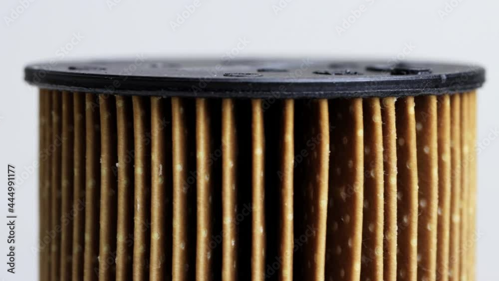 Dirty spent fuel car filter on white background. Concept of high quality car fuel, fuel cleaning, macro, industry