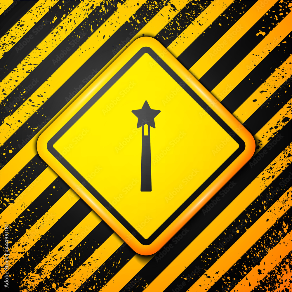 Black Magic wand icon isolated on yellow background. Star shape magic accessory. Magical power. Warning sign. Vector