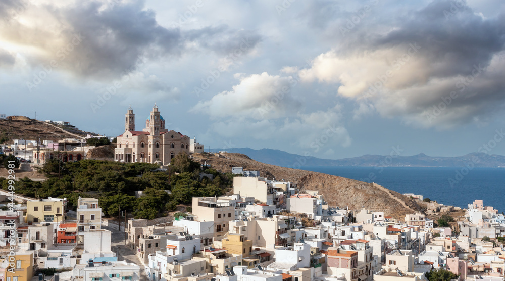 Obraz premium Syros island, Greece, aerial drone view. Ermoupolis and Ano Siros town cityscape, cloudy blue sky background.