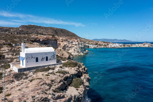 White small church at Psathi port, aerial drone view. Greece Kimolos island, Cyclades. photo