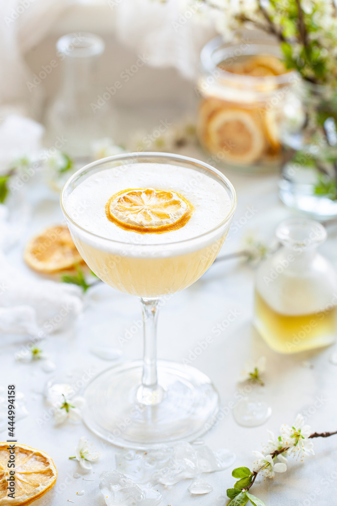 A gin sour flavoured with bergamot and camomile garnished with egg white foam and a slice of dehydrated lemon A gin sour flavoured with bergamot and camomile garnished with egg white foam and a slice of dehydrated lemon