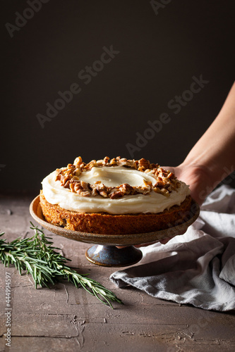 Carrot cake with walnuts in a rustic kitchen photo