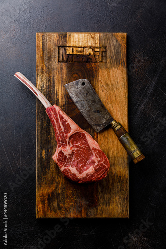Raw Tomahawk Steak and butcher cleaver
