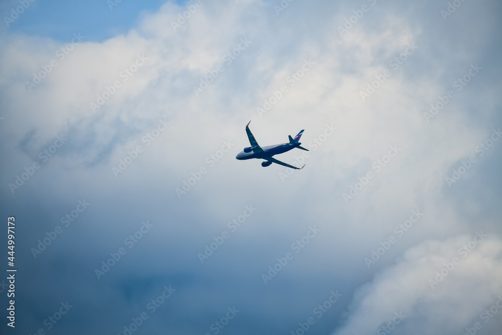 the plane flies through the sky with clouds the plane flies through the sky with clouds