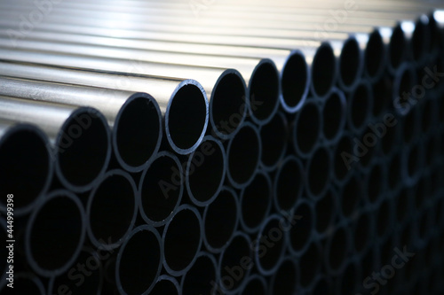 Galvanized steel round pipe background in dark light. 