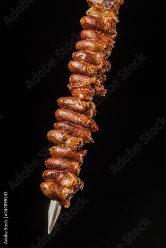 Chicken heart barbecue on skewers on black background. Brazilian gastronomy.