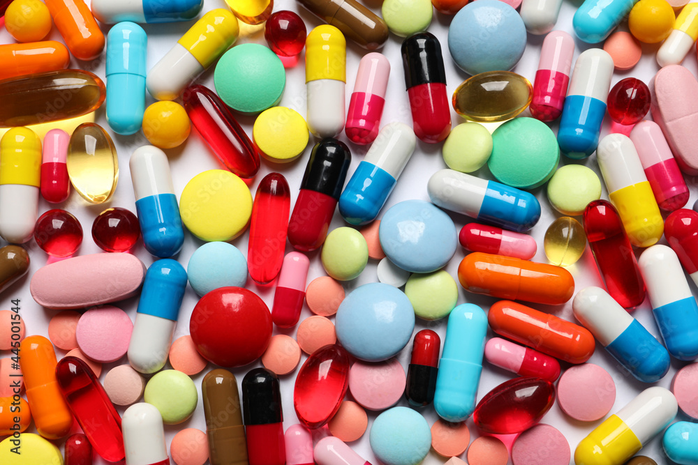 Lots of different colorful pills as background, top view Lots of different colorful pills as background, top view