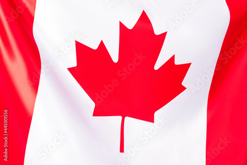 close up of white canadian flag with red maple leaf