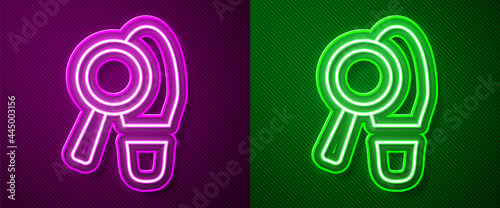 Glowing neon line Magnifying glass with footsteps icon isolated on purple and green background. Detective is investigating. To follow in the footsteps. Vector