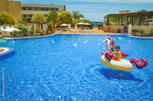 off on vacation - swim with the einchorn ring toy in the hotel swimming pool