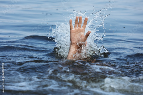 Drowning man reaching for help in sea  closeup