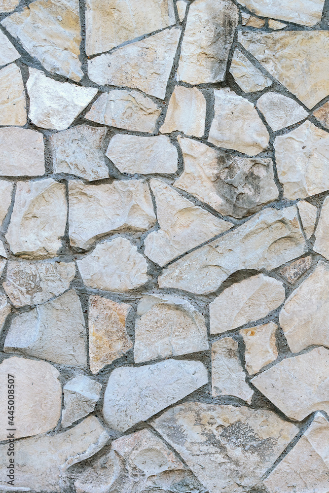Obraz premium stone wall made of sandstone blocks of different sizes as the background